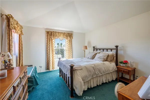 a bedroom with a bed and a dresser in it