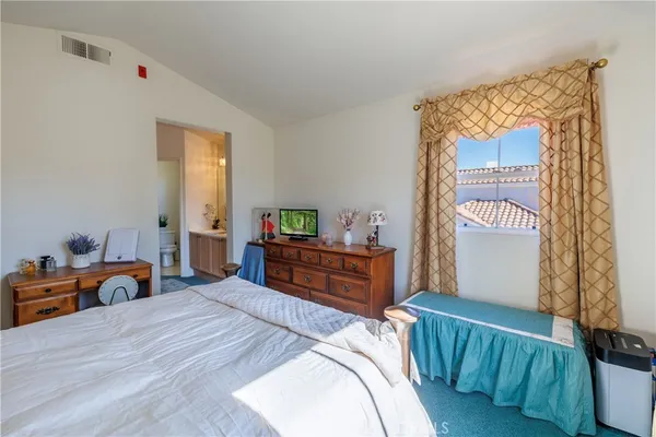 a bedroom with bed and wooden floor