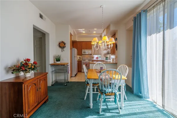 a view of a dining room with furniture and window