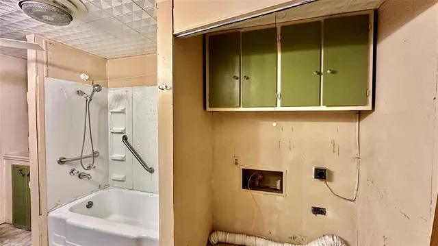 a bathroom with a bathtub and shower
