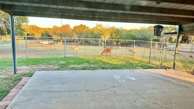 a view of a porch with a floor to ceiling window next to a yard
