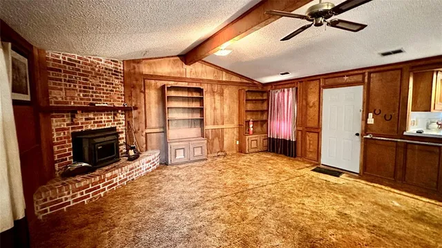 a large bedroom with a bed and a television