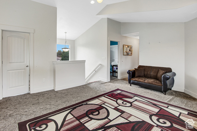 4 Hanauer Place Murray, UT 84107 - Photo 19 of 24 Living room with vaulted ceiling and carpet flooring
