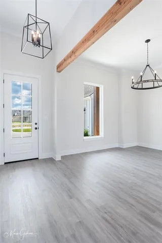 a view of an entryway with wooden floor