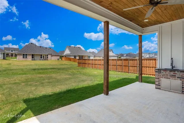 a view of a house with a yard and sitting area