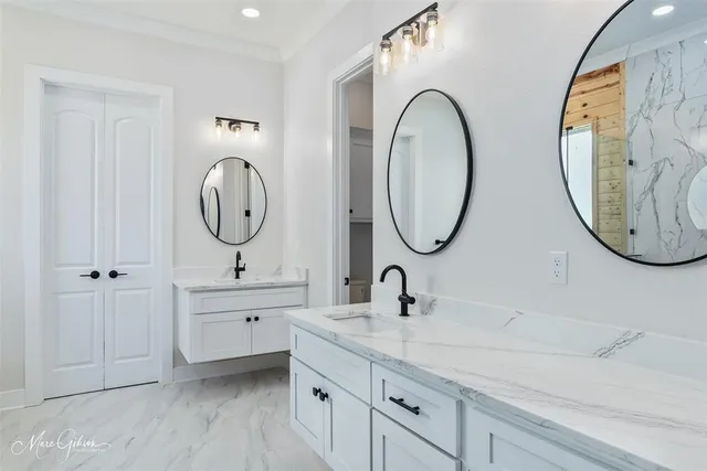 a bathroom with a double vanity sink and a mirror