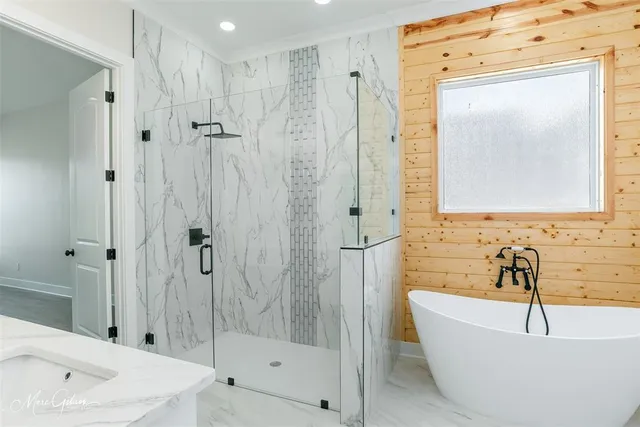 a bathroom with a bathtub and shower