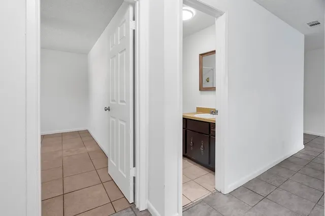 a view of a hallway to rooms and stairs