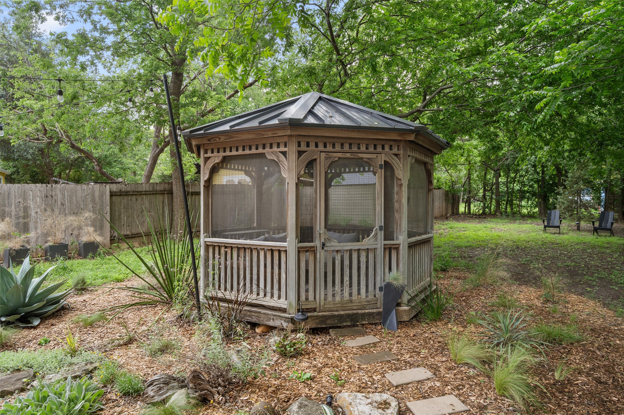 8436 Bangor Bend Austin, TX 78758 - Photo 27 of 29 The screened gazebo feels like a little hideaway, tucked into the trees and ready for slow mornings or shaded evenings.