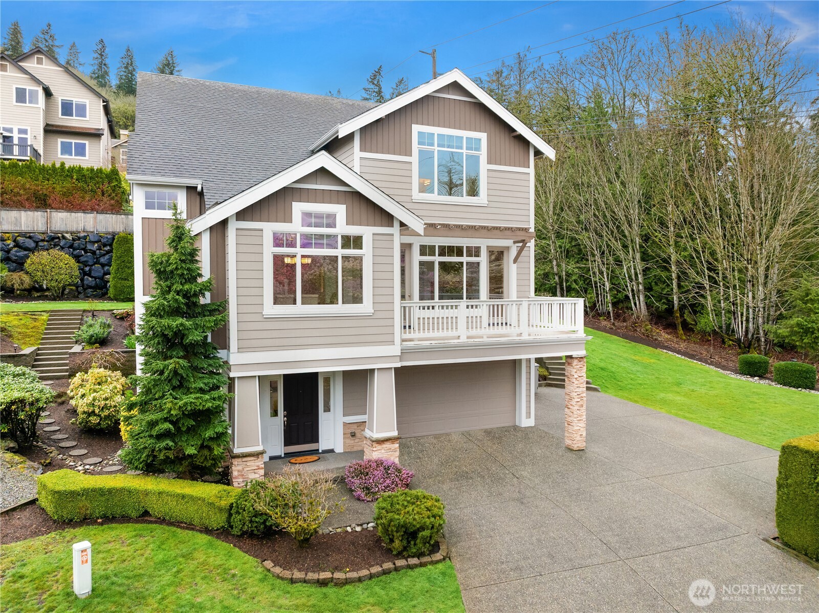 a front view of a house with a yard and garage