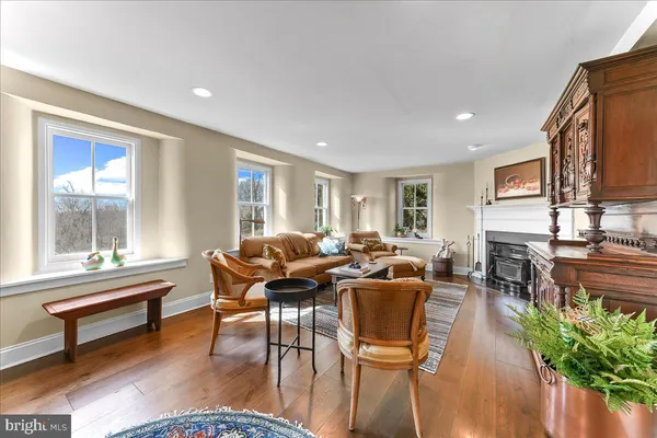 a living room with furniture a rug and a fireplace