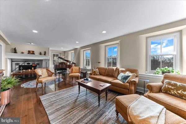 a room with furniture wooden floor and a lamp
