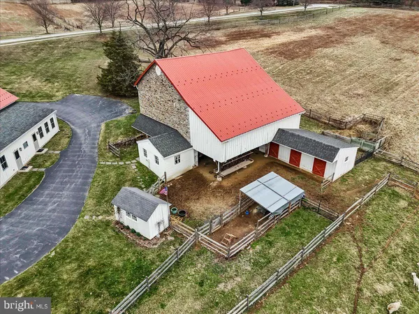 an aerial view of a house with swimming pool and a yard