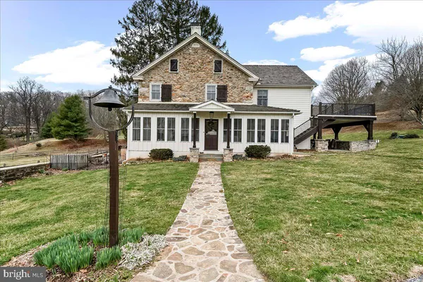 a aerial view of a house with yard and green space