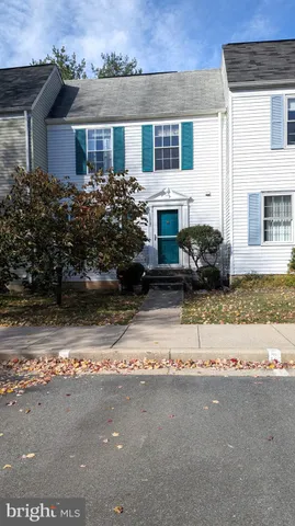 a front view of a house with a yard and a garage