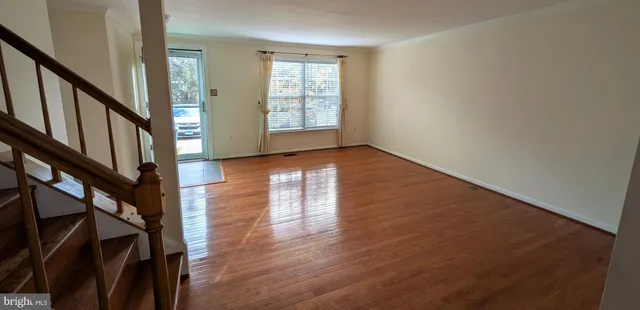 wooden floor in an empty room with a window