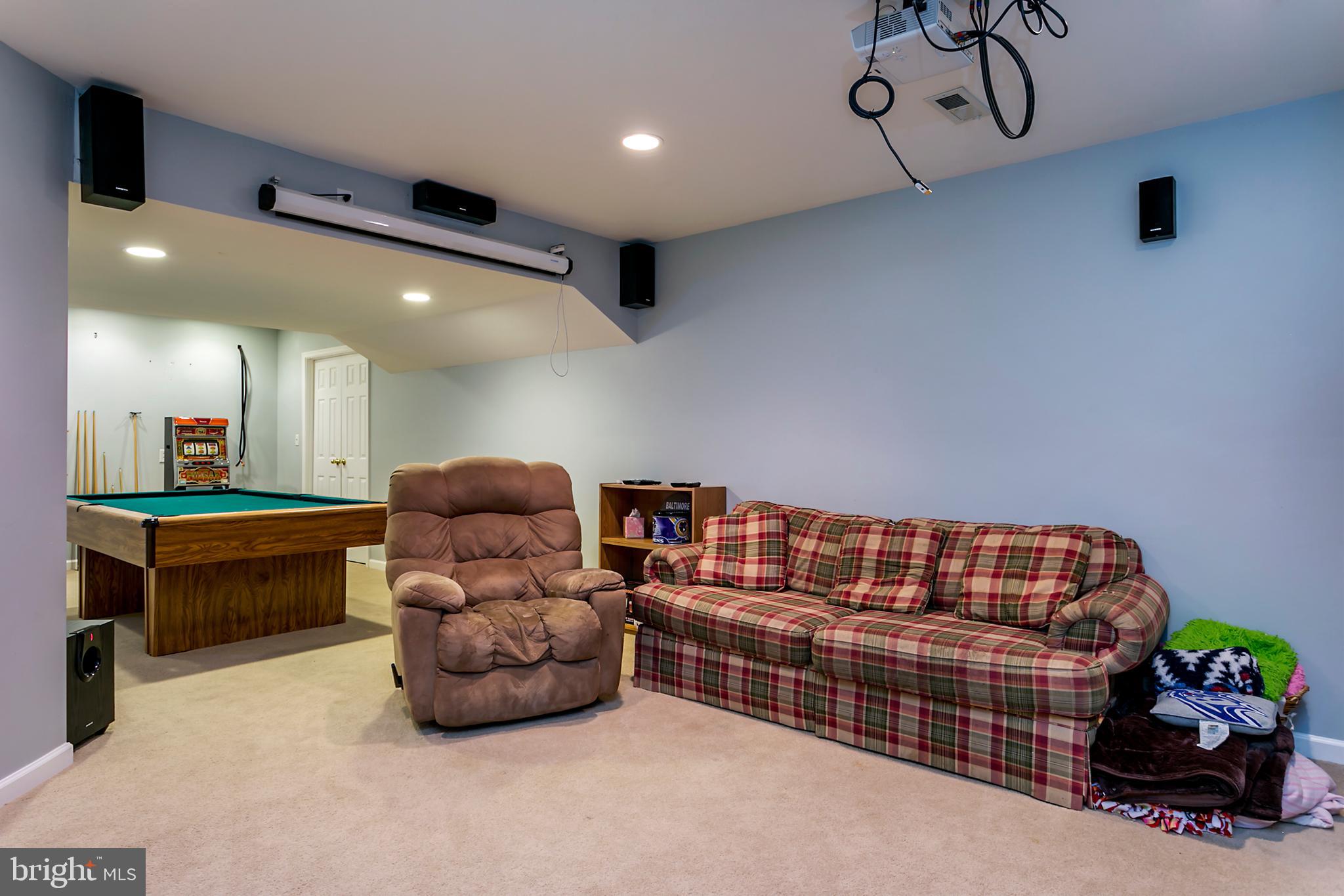 13 Johnson Road Pasadena, MD 21122 - Photo 18 of 28 Basement Rec Room with projector and screen