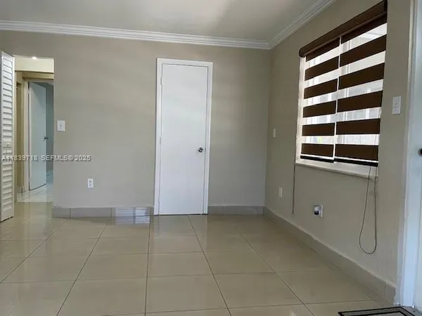 a view of an empty room with a window