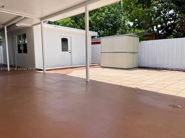 330 West 40th Place Hialeah, FL 33012 - Photo 17 of 20 a view of a white house with a yard and a garage