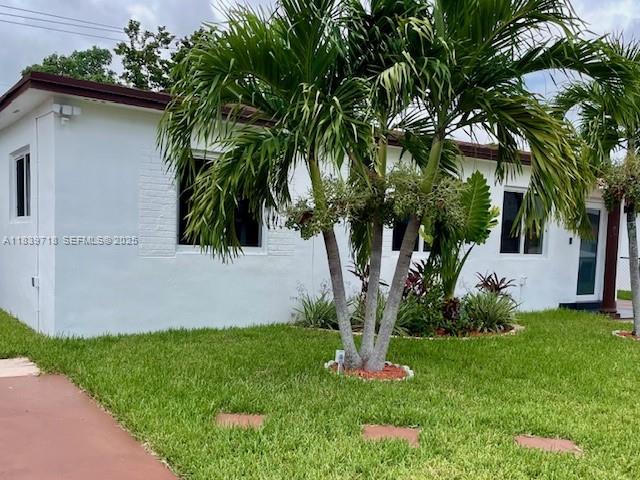 330 West 40th Place Hialeah, FL 33012 - Photo 3 of 20 a front view of a house with garden