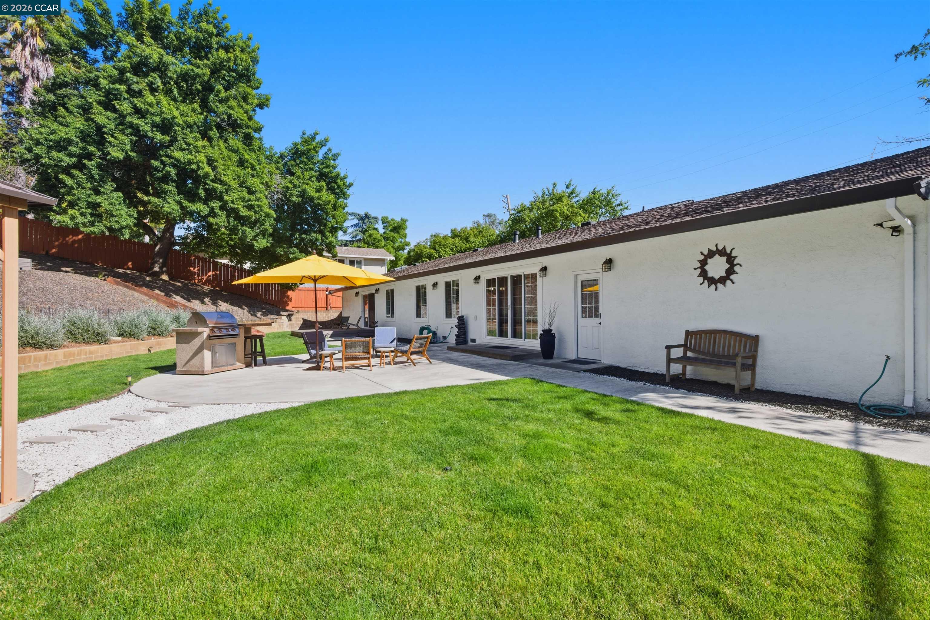 3298 Gloria Terrace Lafayette, CA 94549 - Photo 2 of 40 a view of a house with backyard sitting area and garden