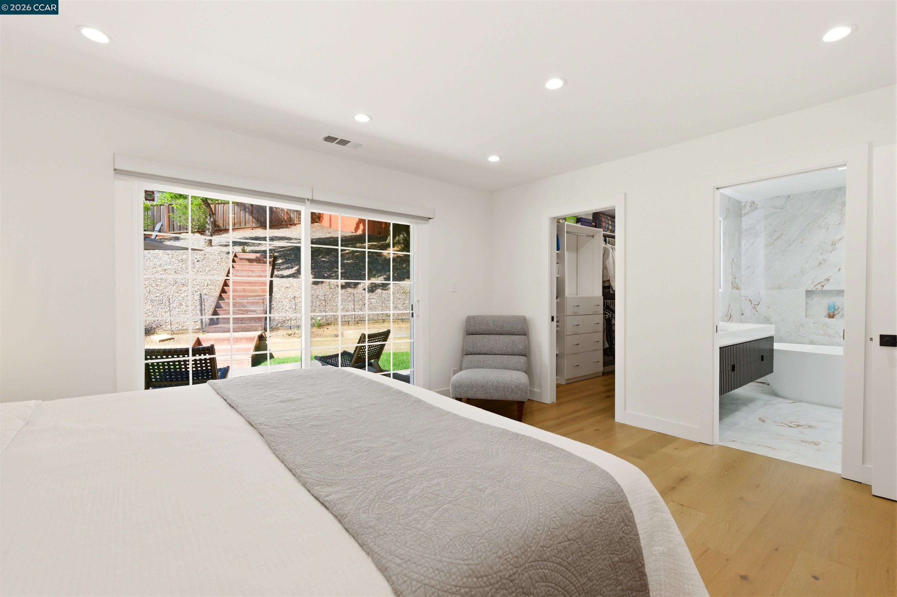 3298 Gloria Terrace Lafayette, CA 94549 - Photo 26 of 40 a bedroom with a bed and wooden floor