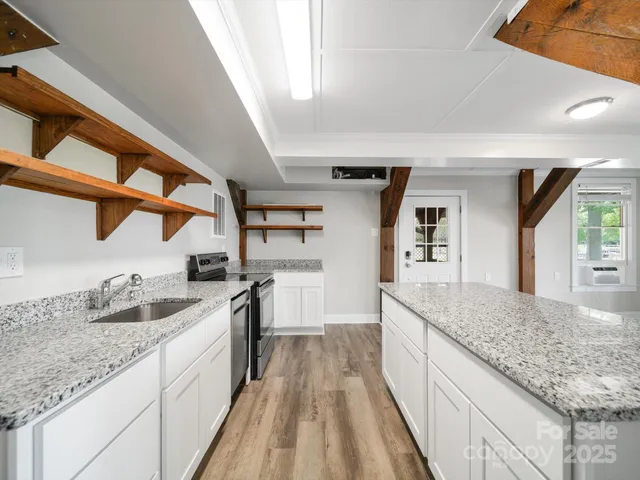 a kitchen with stainless steel appliances granite countertop a stove and a sink