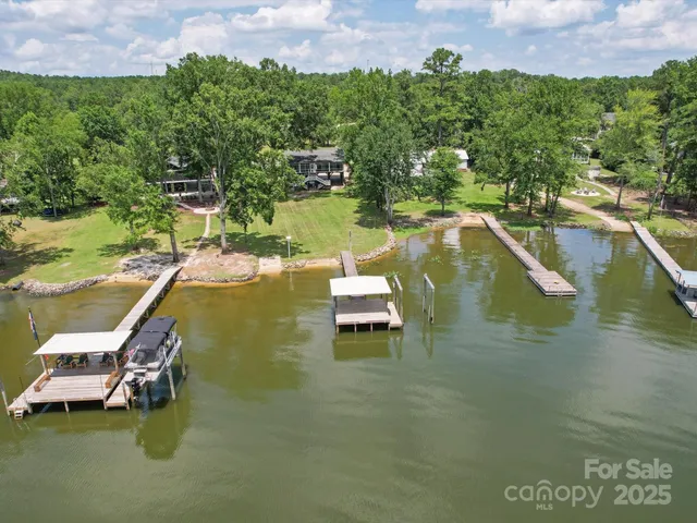 an aerial view of residential houses with outdoor space and street view