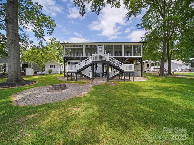 a view of a house with a yard deck and sitting area