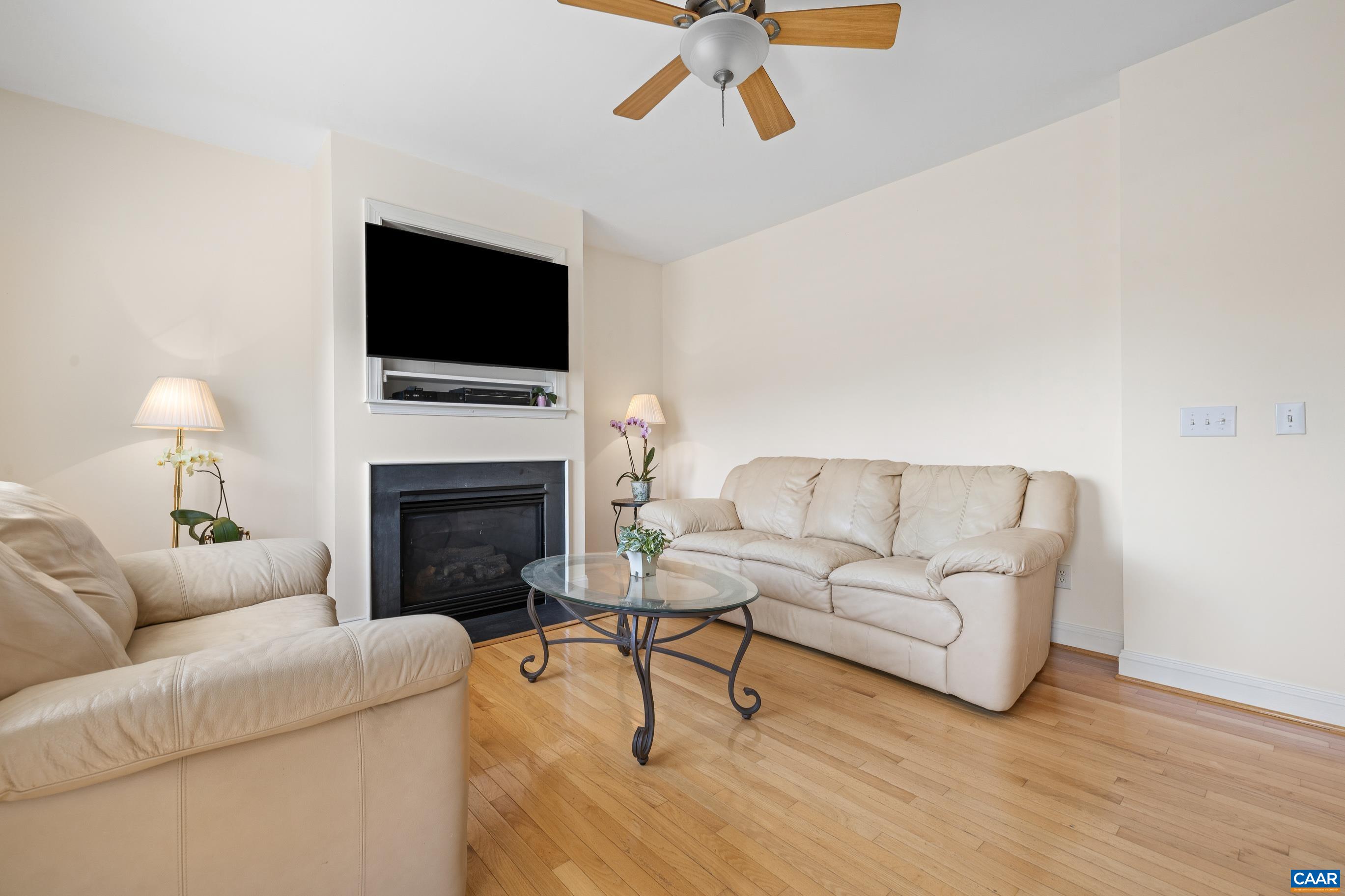1236 Amber Ridge Road Charlottesville, VA 22901 - Photo 14 of 56 a living room with furniture a flat screen tv and a fireplace