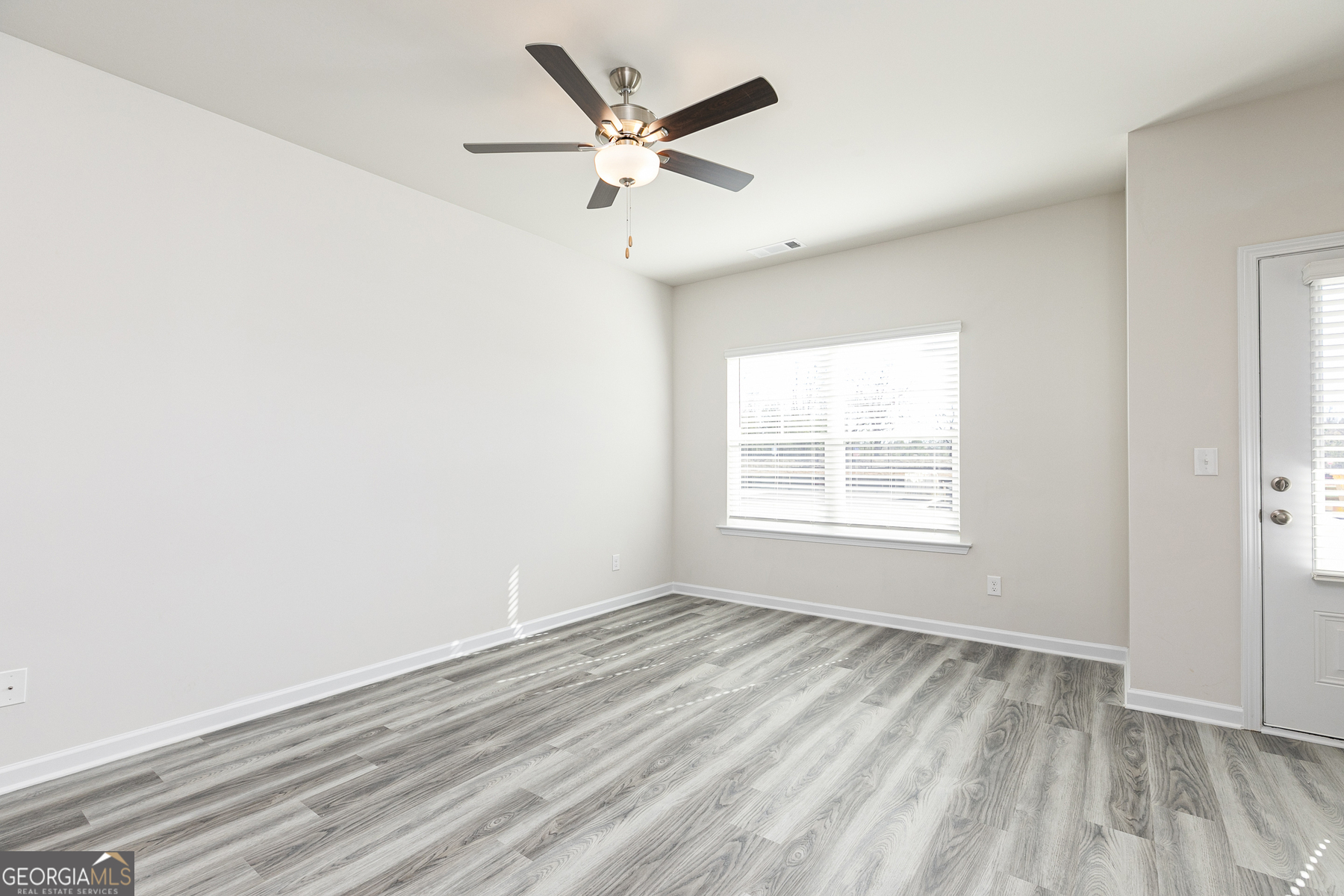 253 Rooker Drive LaGrange, GA 30241 - Photo 9 of 17 wooden floor in an empty room with a window