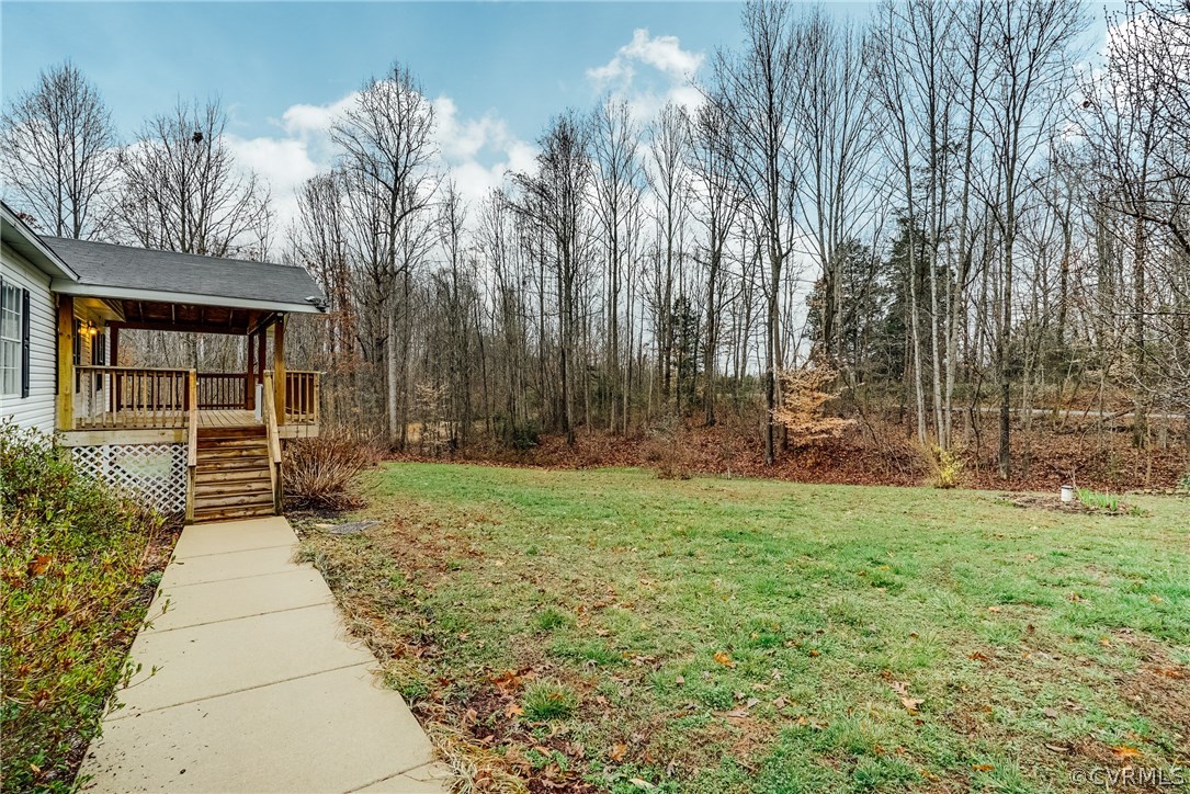 459 Bohannon Road Bumpass, VA 23024 - Photo 19 of 20 a backyard of a house with lots of green space