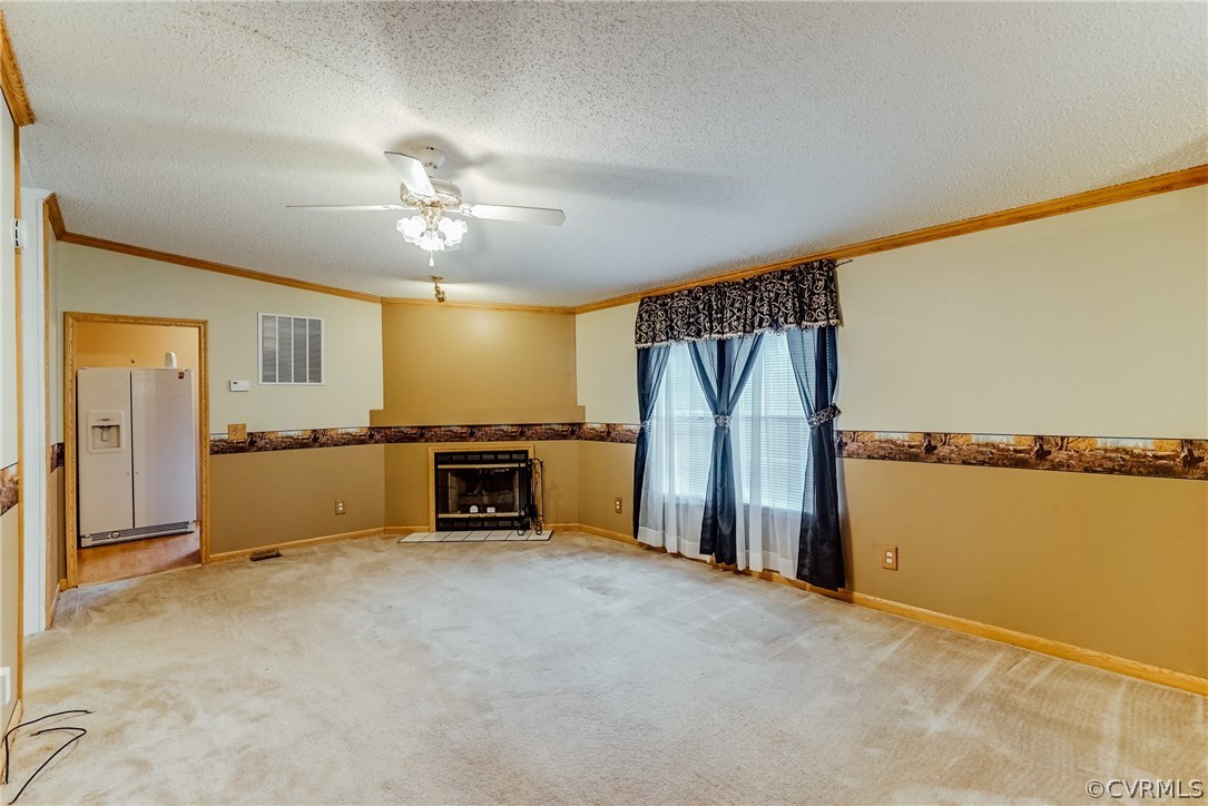 459 Bohannon Road Bumpass, VA 23024 - Photo 8 of 20 a view of a livingroom with furniture and a ceiling fan