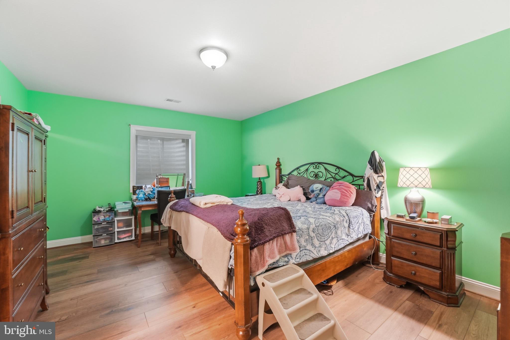 4873 Point Road Warrenton, VA 20187 - Photo 30 of 41 Vibrant green walls enhance cozy bedroom charm.
