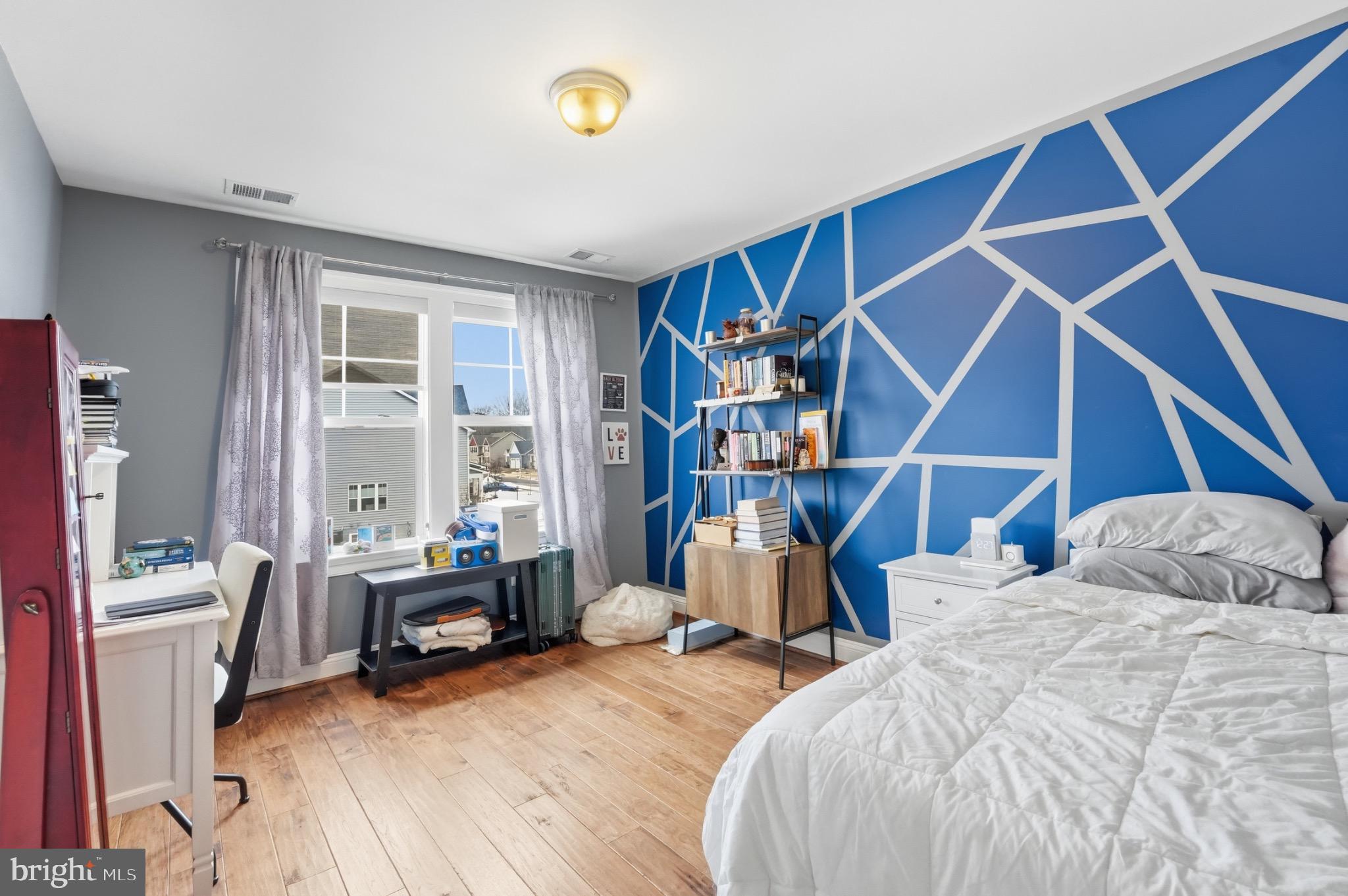 4873 Point Road Warrenton, VA 20187 - Photo 34 of 41 Vibrant bedroom with geometric accent wall.