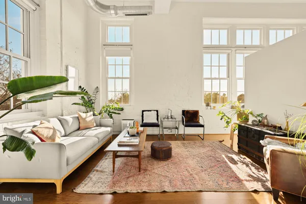 a living room with furniture rug and window