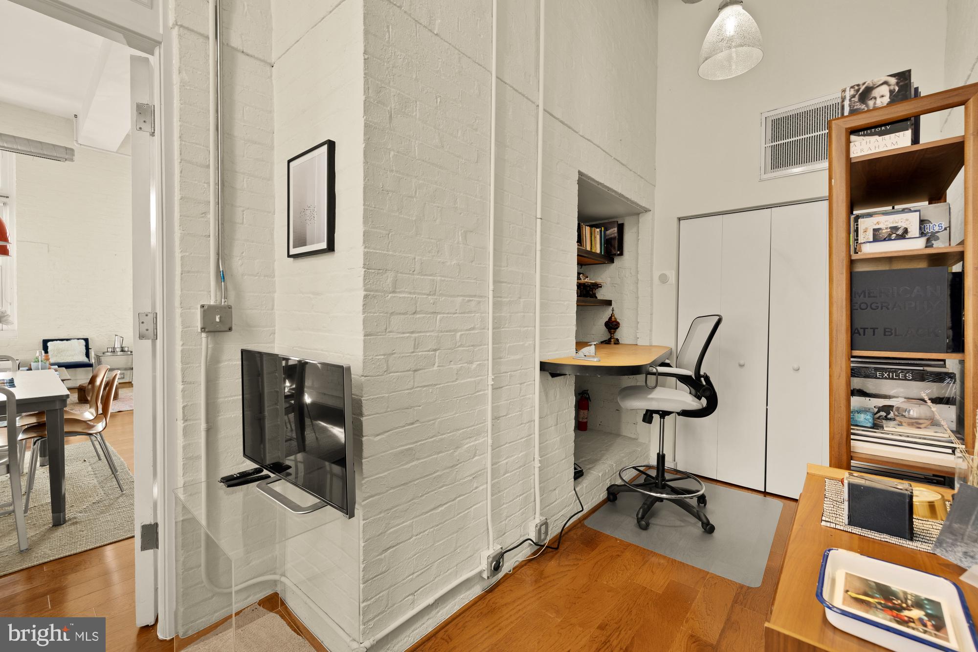 440 12th Street Northeast, Unit 211 Washington, DC 20002 - Photo 15 of 20 a view of a workspace with furniture and a flat screen tv