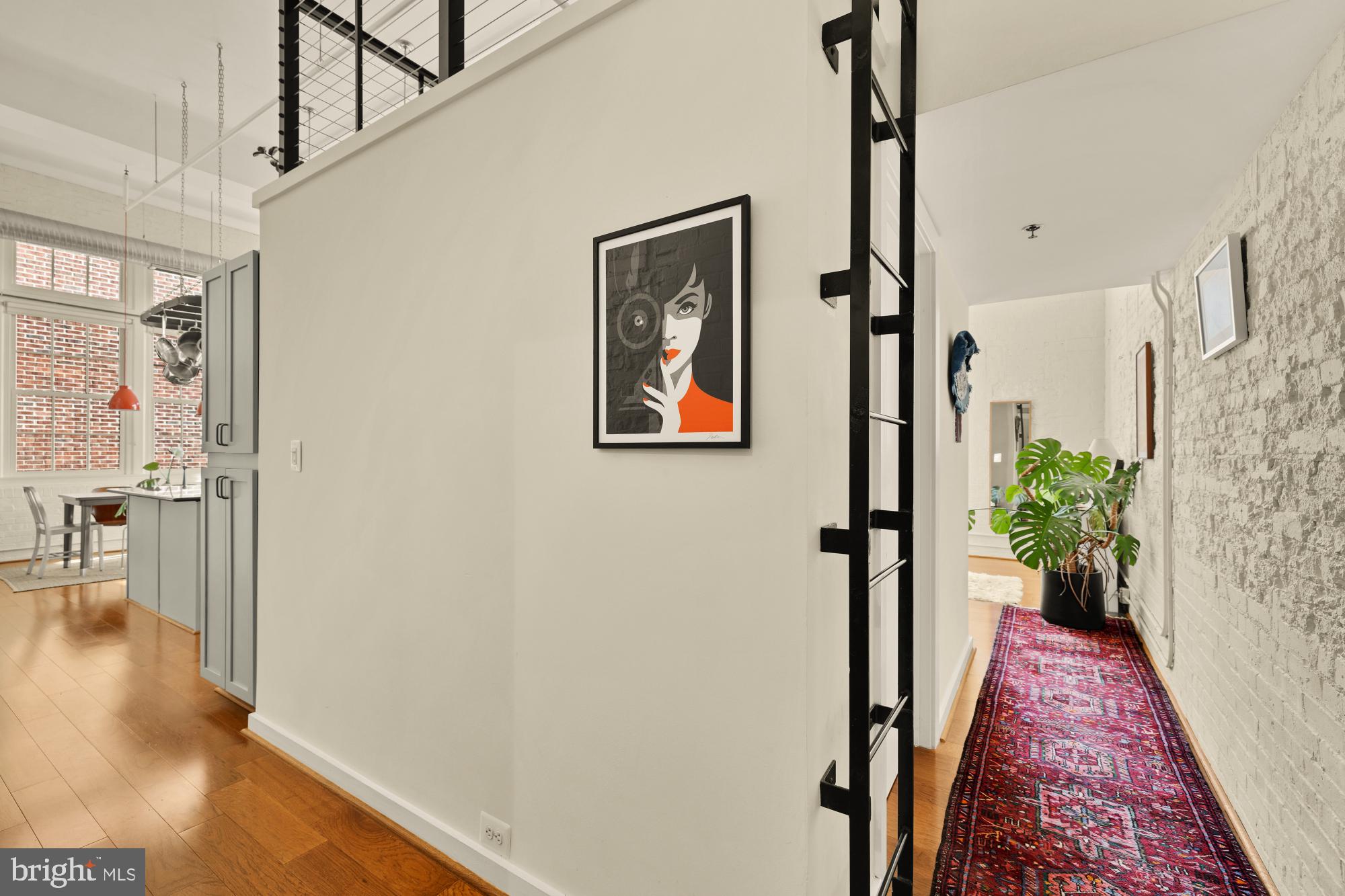 440 12th Street Northeast, Unit 211 Washington, DC 20002 - Photo 7 of 20 a view of a hallway with wooden floor and stairs