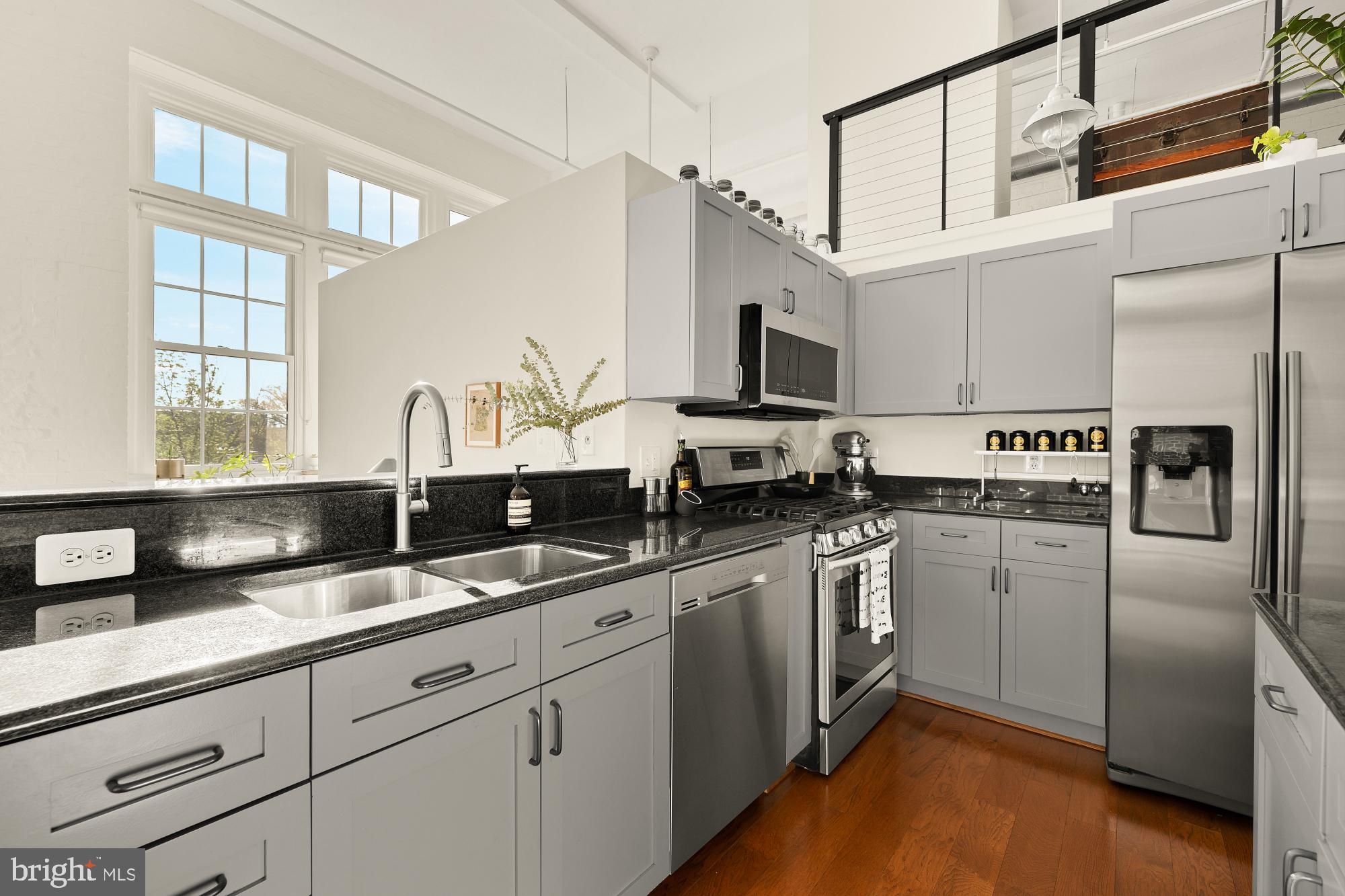 440 12th Street Northeast, Unit 211 Washington, DC 20002 - Photo 9 of 20 a kitchen with stainless steel appliances granite countertop a sink a stove and refrigerator