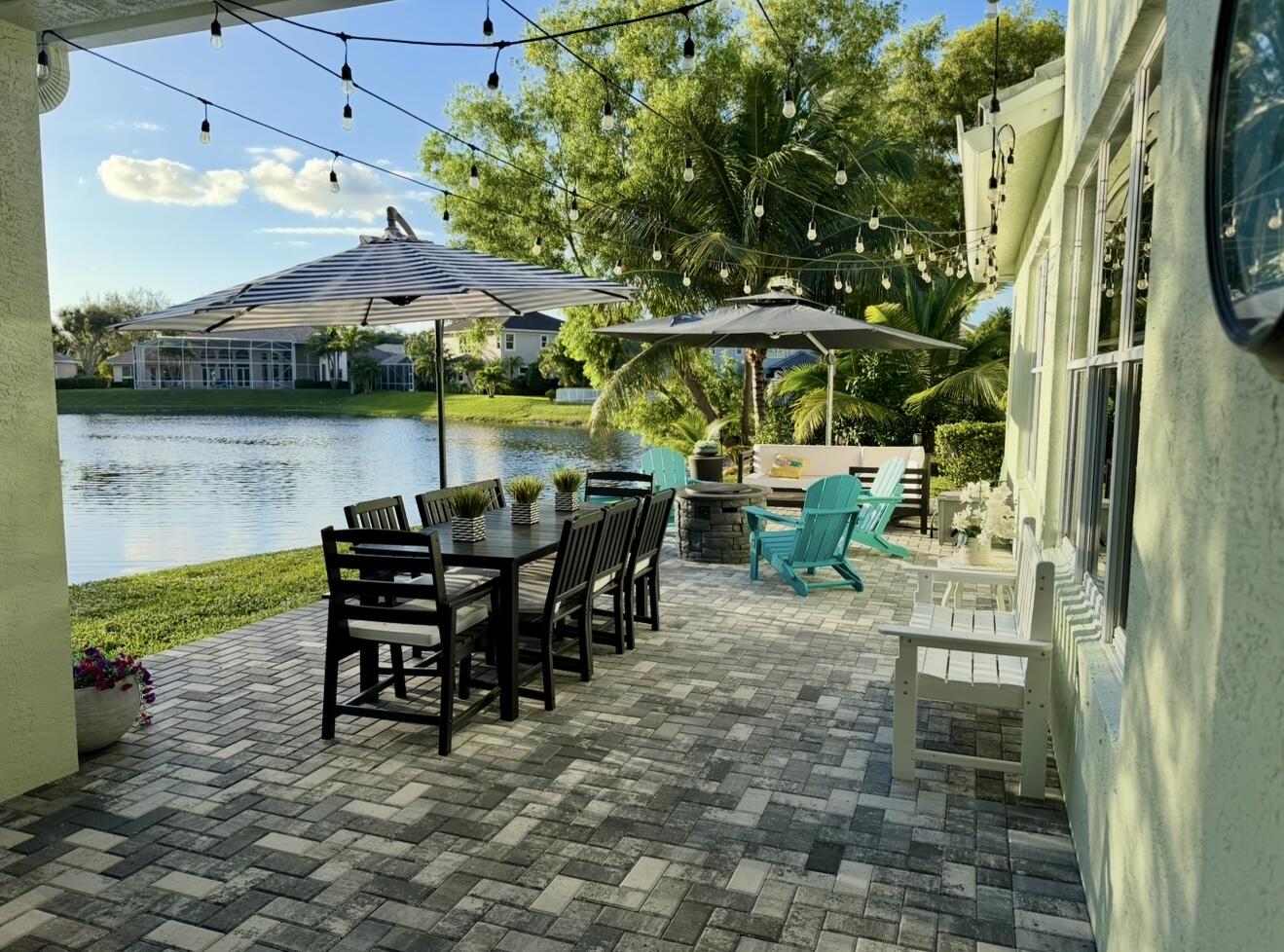 265 Swallowtail Lane Jupiter, FL 33458 - Photo 2 of 42 a view of a patio with table and chairs under an umbrella