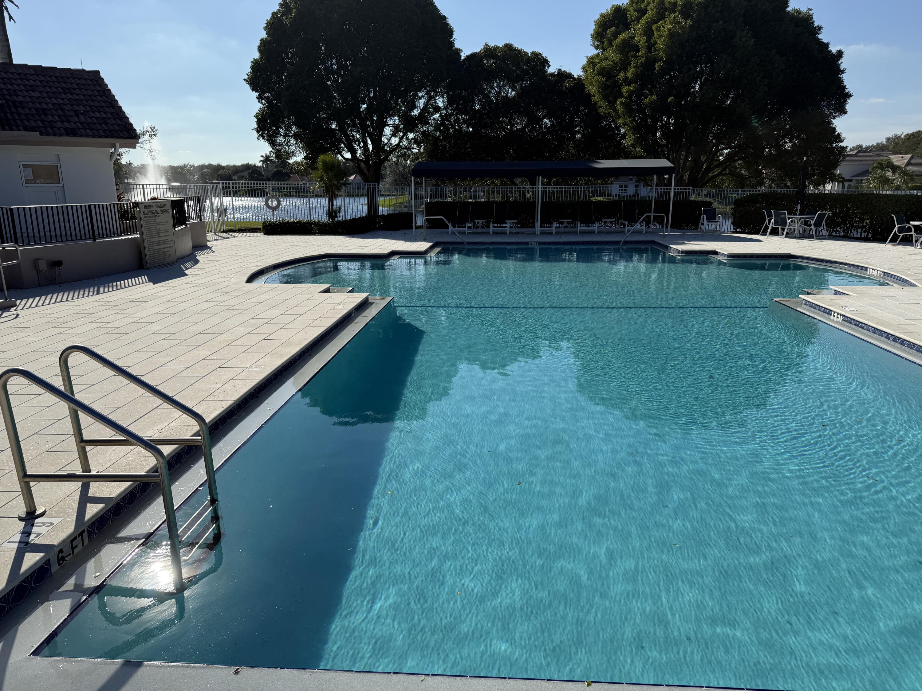 265 Swallowtail Lane Jupiter, FL 33458 - Photo 33 of 42 a view of swimming pool with seating space and yard