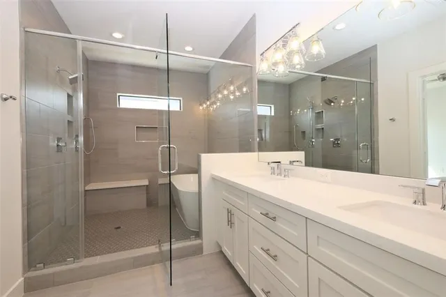 a bathroom with a shower sink and mirror