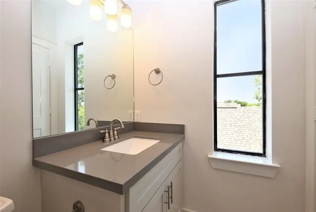 a bathroom with a sink vanity and a mirror