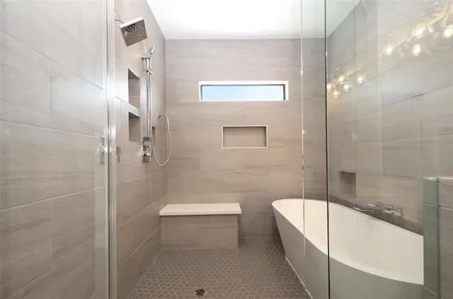 a bathroom with a bathtub and a shower