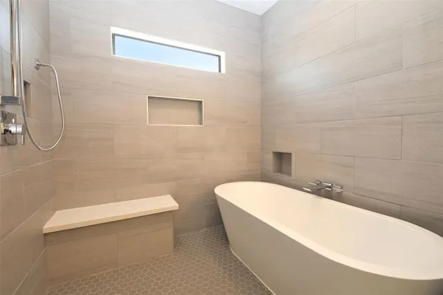 a bathroom with a white toilet and a bathtub
