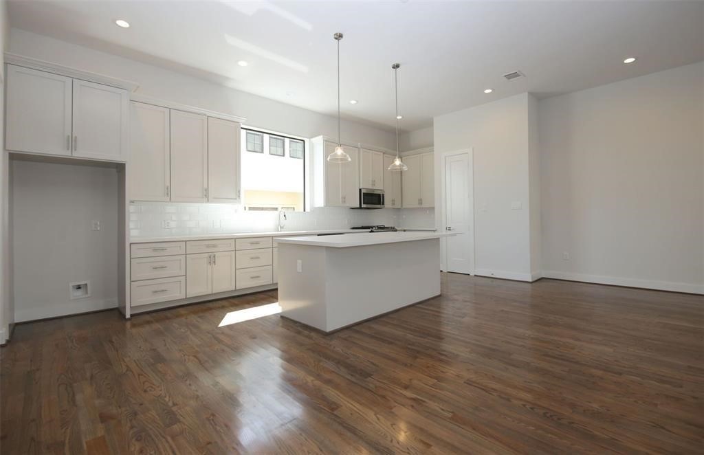 820 West 22nd Street Houston, TX 77008 - Photo 3 of 28 a large kitchen with stainless steel appliances granite countertop a large counter top a sink and a stove