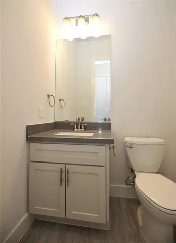 a bathroom with a toilet a sink and mirror