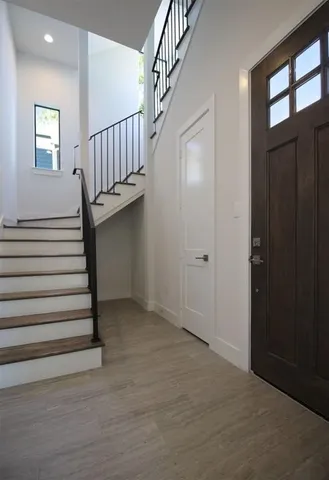 a view of entryway with stairs and wooden floor