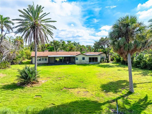 a wooden bench sitting in backside of a house
