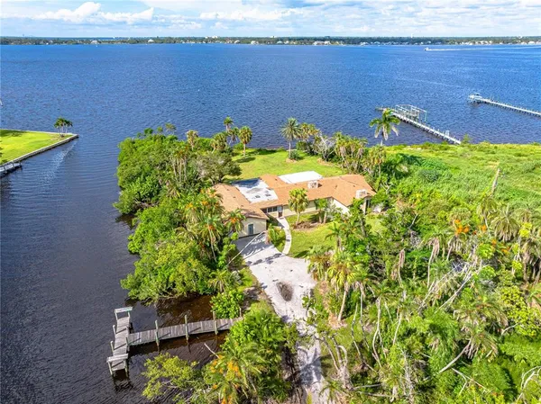 an aerial view of a house with a swimming pool yard and lake view